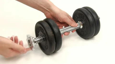 Adding weights to a dumbbell Stock-Footage 20435959