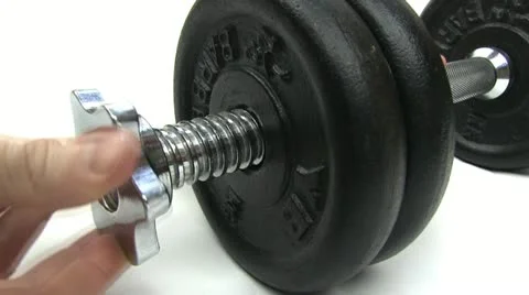 Adding weights to a dumbbell Stock-Footage 20435988