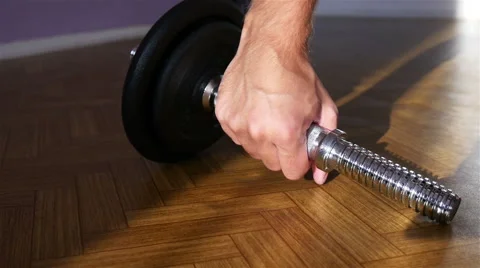 Adding Weights to a Dumbbell Stock Footage 55289213
