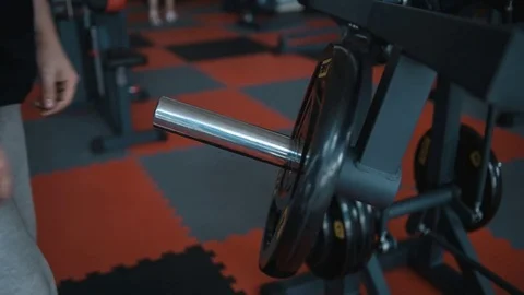 Adding weights for gym machine Stock Footage 82352045