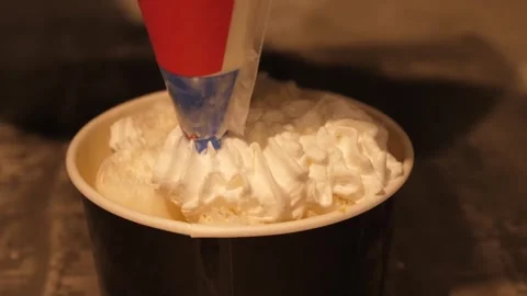 Adding Whipped Cream to Rolled Ice Cream Dessert Close Up Video stock 345293119