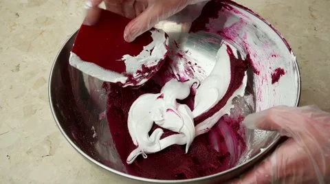 Adding a whipped egg whites cream to almond meal with fruit jam. Stock Footage 62425731