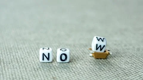 Adding white cube with letter w to the word no creating new word now on grey  Stock Photos