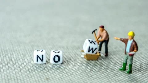 Adding white cube with letter w to the word no creating new word now on grey  Stock Photos