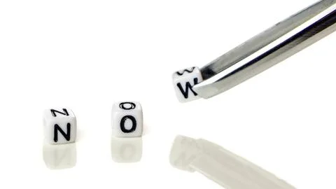 Adding white cube with letter w to the word no creating new word now on white Stock Photos