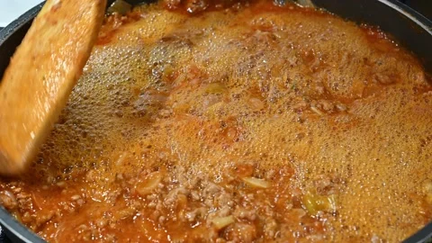 Adding white wine to minced beef Stock Footage 219878738