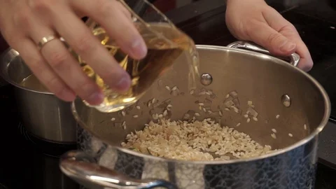 Adding wine and herbs to rice Stock Footage 112127086