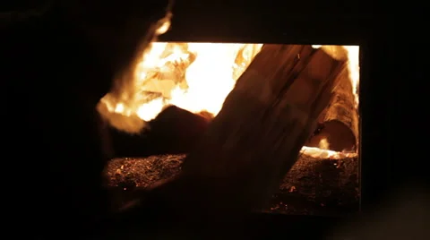 Adding Wood to Maple Sap Boiler-tight shot Stock Footage 5502450