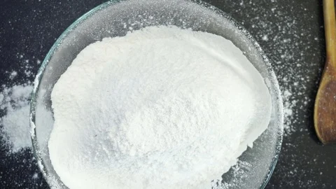 Adding yeast and dough kneading overhead Stock Footage 121119439