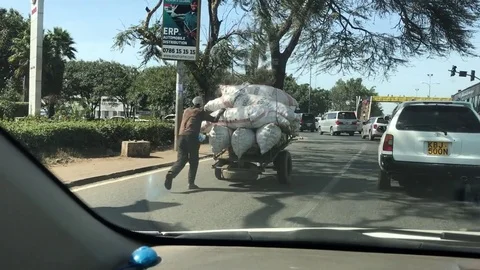 Addis Ababa, Ethiopia - two men push a produce cart Stock Footage 79913342