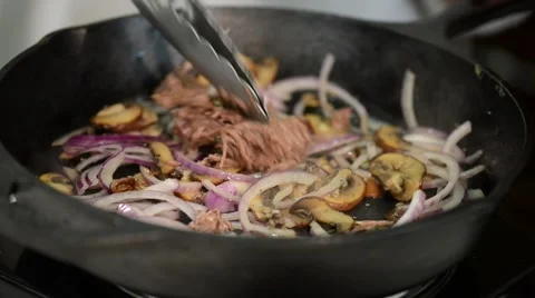 Addition of beef meat in a cast iron skillet. Stock Footage 54782554