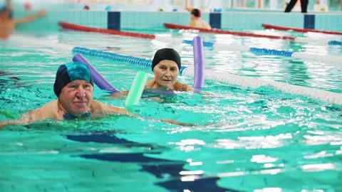 Additional swimming equipment. Side view of an elderly white man in a swimming Stock Footage 224776563