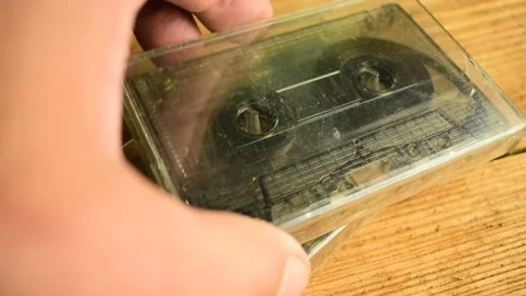 Adds a cassette tape to the table Stock Footage 135417205