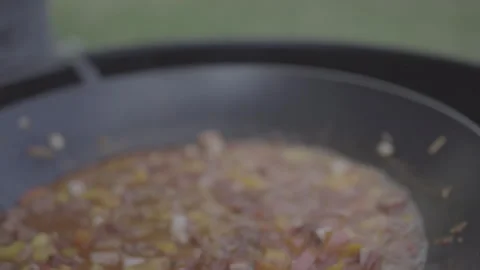 Adds pepper to the pan with the food being cooked Stock Footage 266799375