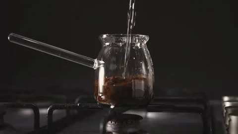 Adds water to coffee cup Stock Footage 168751406