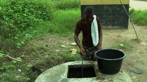 ADEISO BOY GETS WATER FROM WELL Stock Footage 58066144