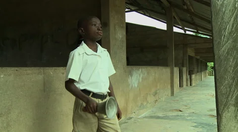 ADEISO BOY STUDENT RINGS BELL TO START SCHOOL Stock Footage 58066085