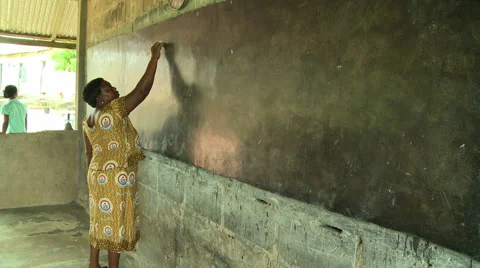 ADEISO CLASSROOM TEACHER WRITES ON BLACKBOARD Stock Footage 58066710