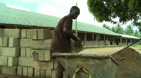 ADEISO MAN LOADING BLOCKS INTO WHEELBARROW Stock Footage 57982690