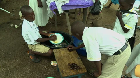 ADEISO SCHOOL LUNCH: BOY STUDENT WASHES DISHES 1 Stock Footage 58067806