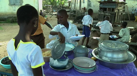 ADEISO SCHOOL LUNCH: BOY STUDENT SERVES MEAL Stock Footage 58068464