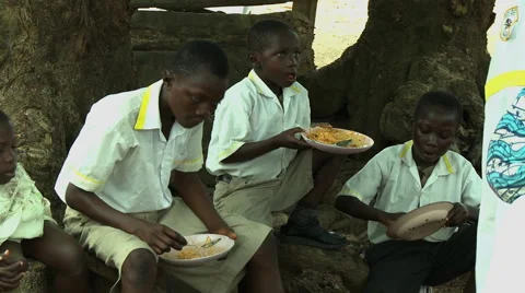ADEISO SCHOOL LUNCH: BOY STUDENTS EAT Stock Footage 58067523