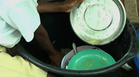 ADEISO SCHOOL LUNCH: CLOSE UP BOY STUDENT WASHES DISHES Stock Footage 58067774
