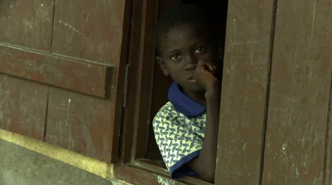ADEISO STUDENT LOOKING OUT WINDOW Stock Footage 57981402