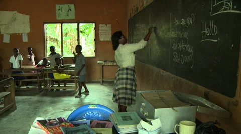 ADEISO TEACHER WRITES ON BLACKBOARD Stock Footage 57981537
