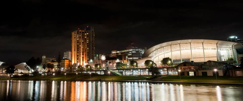 Adelaide skyline illuminated at night, lights reflecting in the torrens lake. Stock Photos