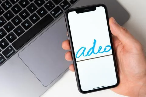 Adeo mobile application on the smartphone screen. Make purchases while sitting Stock Photos