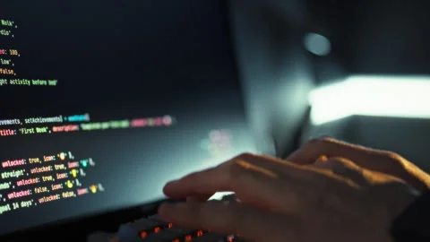 An adept developer swiftly keys in intricate code on the keyboard driving in 스톡 동영상 331315258