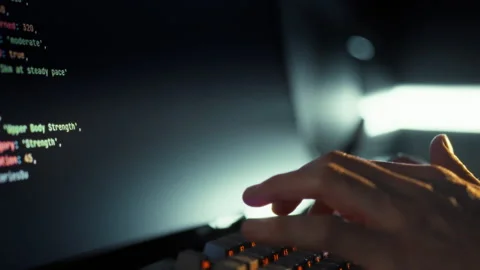 An adept software developer rapidly keys in intricate code leveraging artifi Video stock 331457980