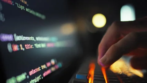 An adept software engineer rapidly inputs intricate programming code on comp 스톡 동영상 331315314