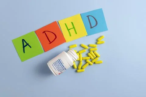ADHD abbreviation on multi-colored paper and a Methylphenidate medical pills Stock Photos