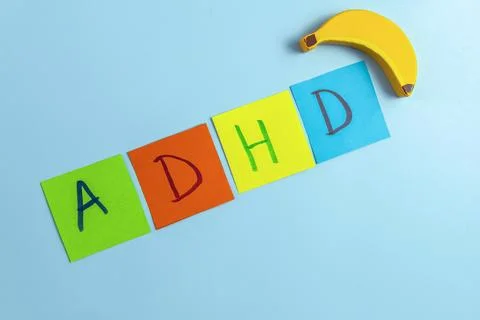 ADHD abbreviation on multi-colored paper and toy banana. Attention Deficit Stock-Fotos