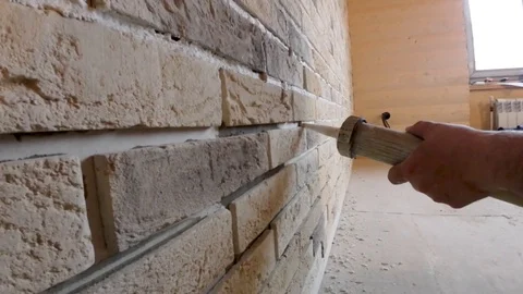 Adhesive joints, gluing decorative stone on the wall, for wall design Stock Footage 89610992
