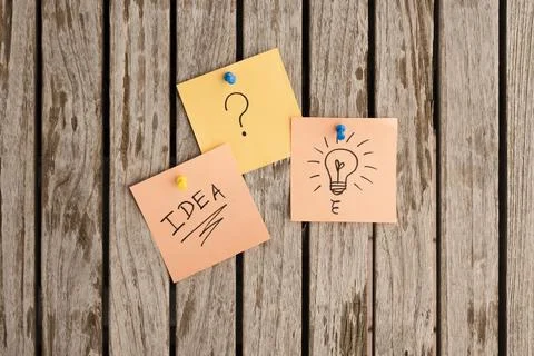 Adhesive notes attached with colorful push pins bulletin board Stock Photos