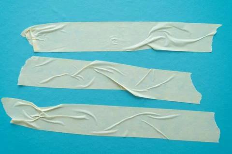 Adhesive tapes on a light blue background – texture with creases and contrasts Stock Photos