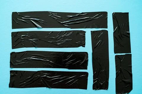 Adhesive tapes on a light blue background – texture with creases and contrasts Stock Photos