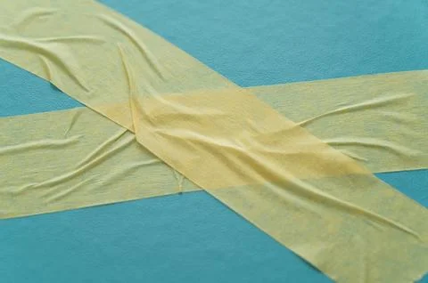 Adhesive tapes on a light blue background – texture with creases and contrasts Stock Photos