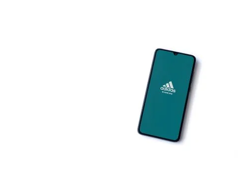 Adidas Running app launch screen with logo on the display of a black mobile s Stock Photos