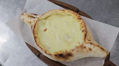 Adjarian khachapuri, open bread stuffed with cheese and egg yolk. Khachapuri is Stock Footage 134611781