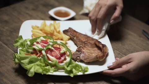 Adjust and clean steak dish Stock Footage 100875795