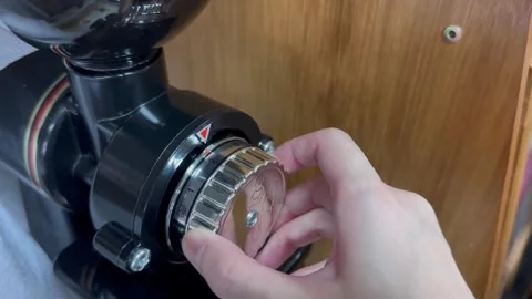 Adjust the level of the coffee grinder. Stock Footage 249374387