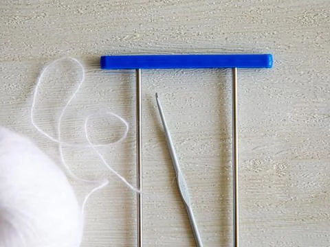 Adjustable crochet fork for making lace, crocheting hook and woolen yarn ball on Stock Photos