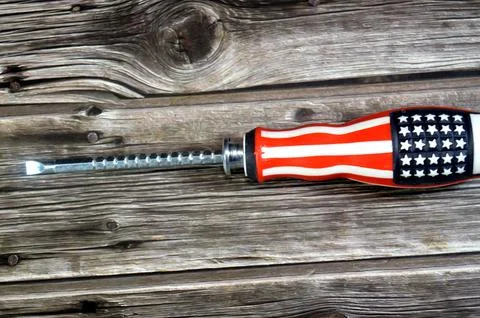 An adjustable double-sided screwdriver patterned with the American flag, a .. Stock Photos