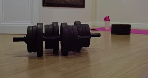 Adjustable Dumbbells in a Stylish, Contemporary Workout Space Designed for Stock Footage 309517352