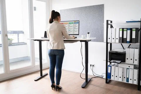 Adjustable Height Office Desk. Working Stock Photos