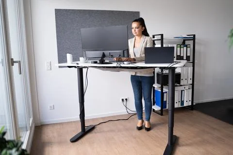 Adjustable Height Office Desk. Working Stock Photos